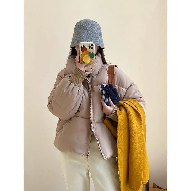 Beige padded puffer jacket with high collar and front zipper, long sleeves