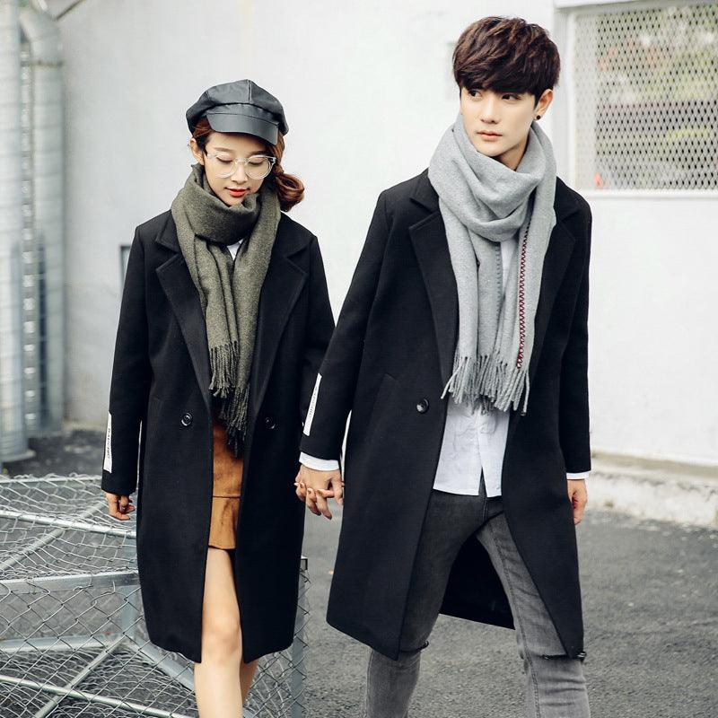 Men's black wool trench coat with notched lapels and button-front closure, long length.