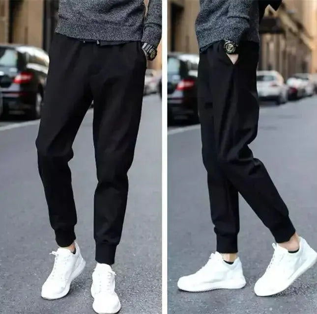 Black jogger pants with cuffed hem and relaxed tapered leg