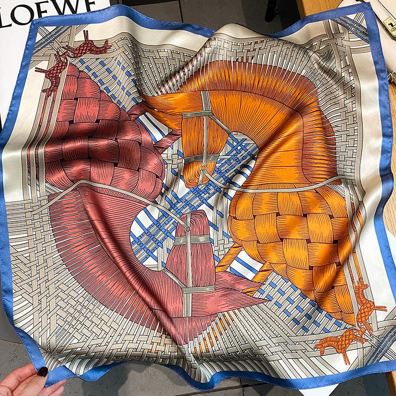 Cream, orange, and red patterned silk scarf with architectural motif and blue trim.