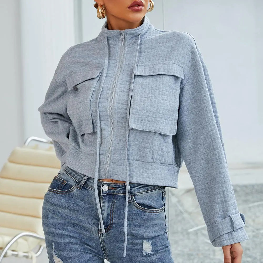 Grey slim zip-up ladies jacket with stand collar, button flap chest pockets, long sleeves
