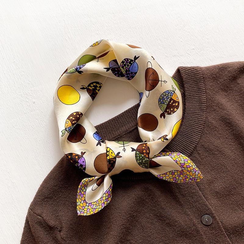 Small scarf, cream with colorful bird motifs, knotted around neckline