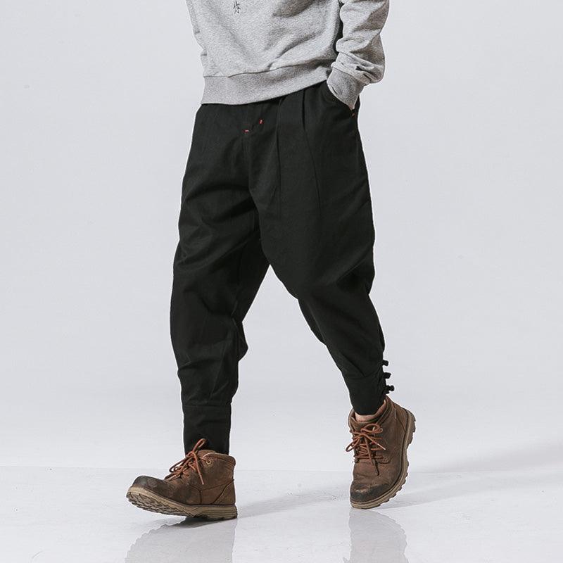 Black cotton-linen harem pants with elastic waist, drawstring, and side pockets