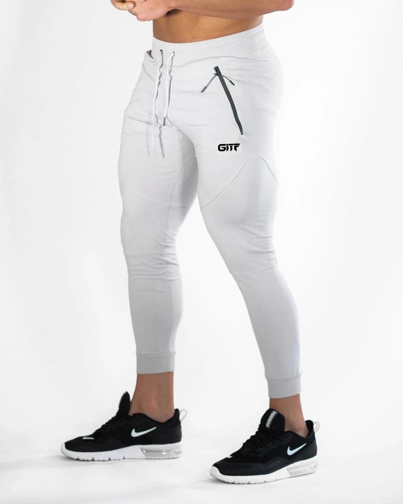 White sport pencil pants with drawstring waist and cuffed 3/4 tapered legs.