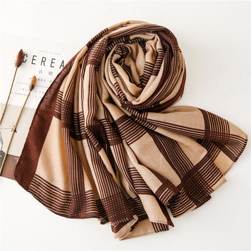 Light brown silk scarf with bold striped grid and fringe ends.