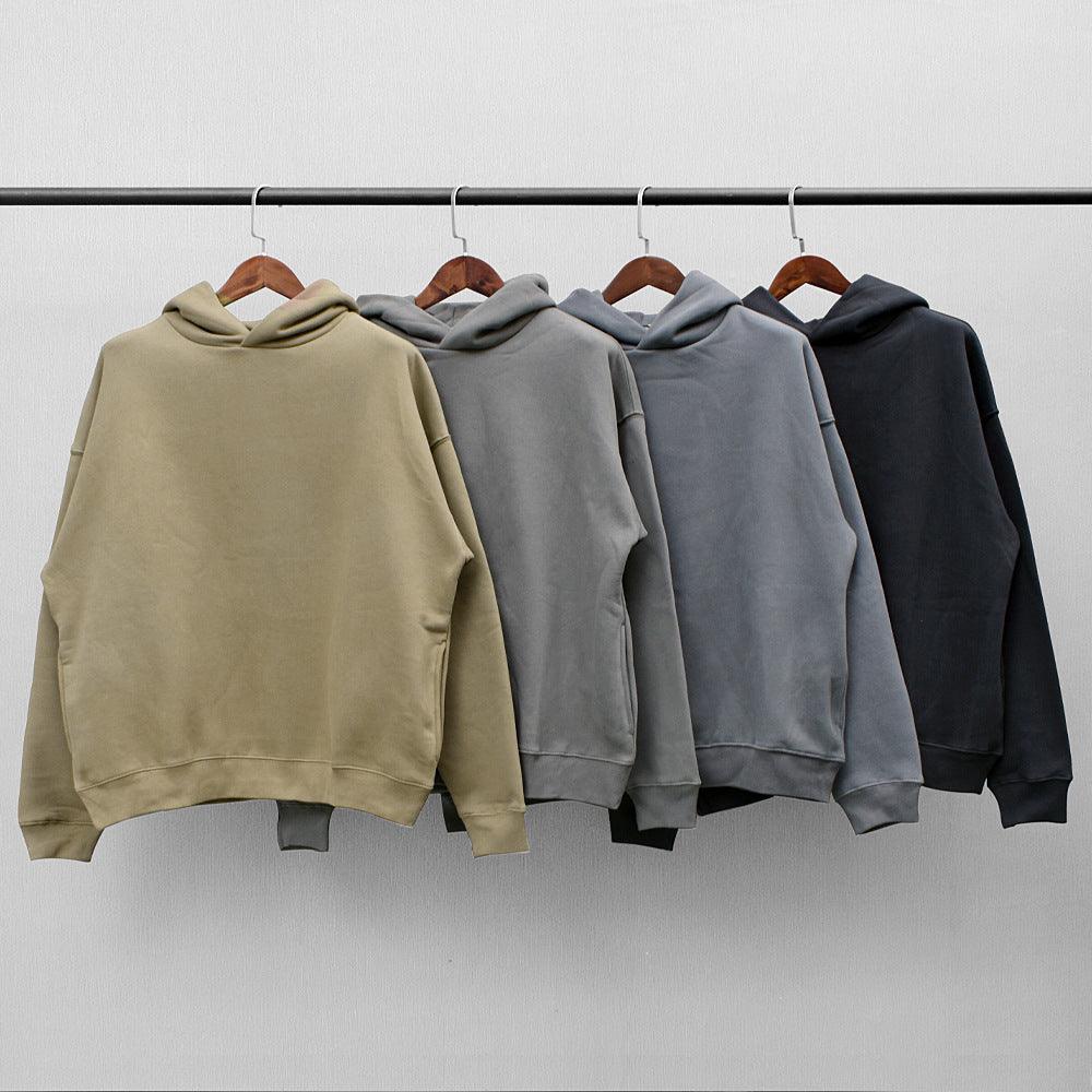 Men's fleece hooded sweaters hanging in assorted colors: khaki, grey, and dark