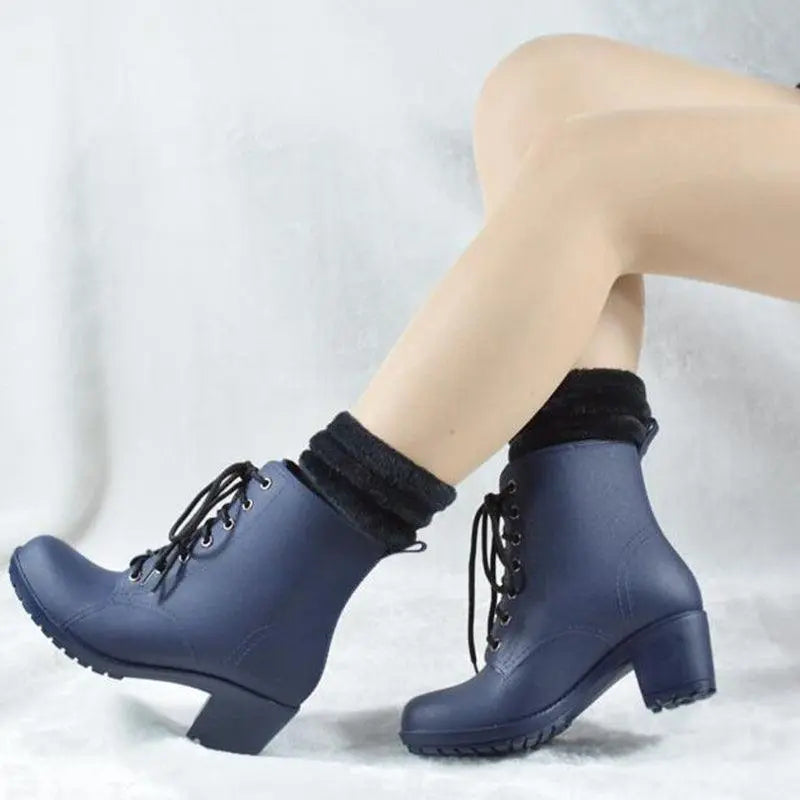 Navy high-heeled rain boots with lace-up front and dark block heel