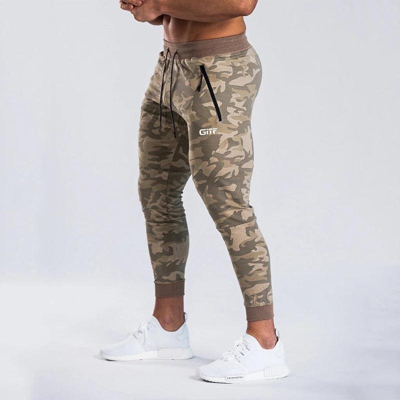 Army camouflage sport pencil pants with drawstring waist and tapered cuffed legs.