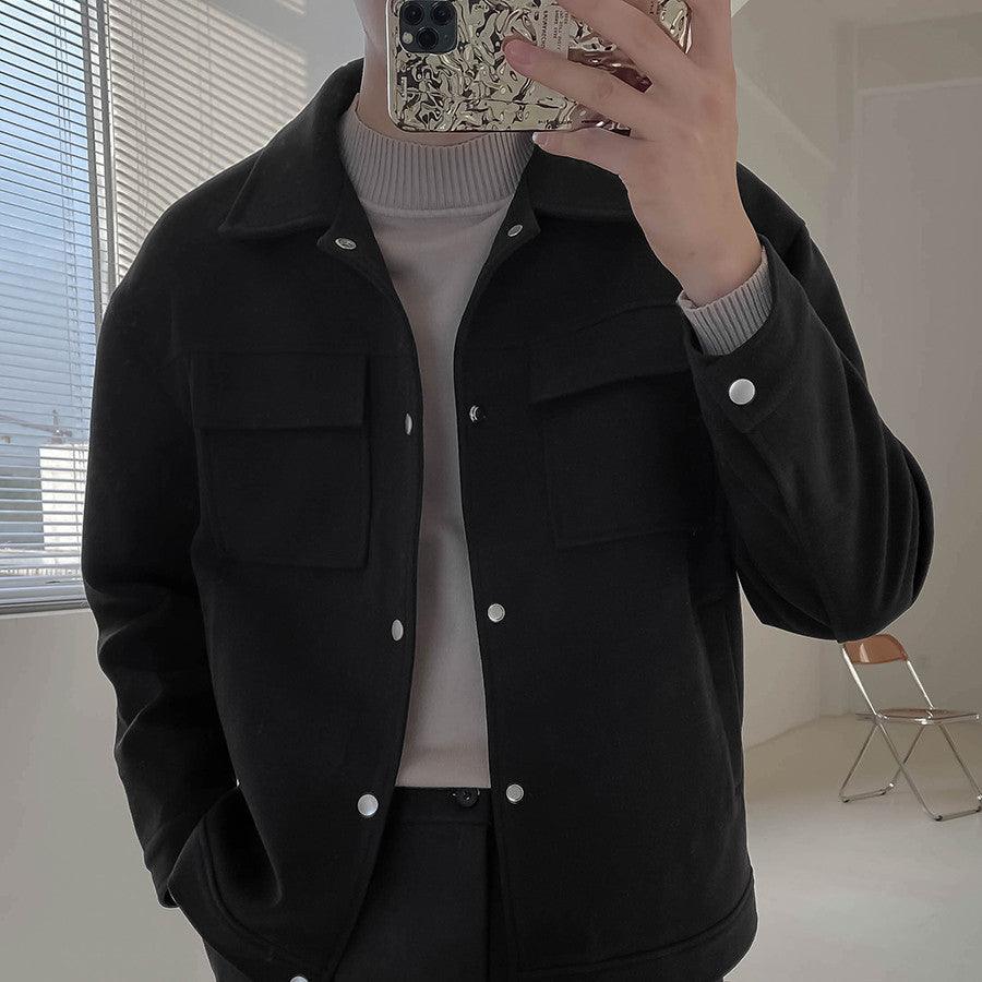Men's black short work jacket with button front and flap chest pockets, long sleeves