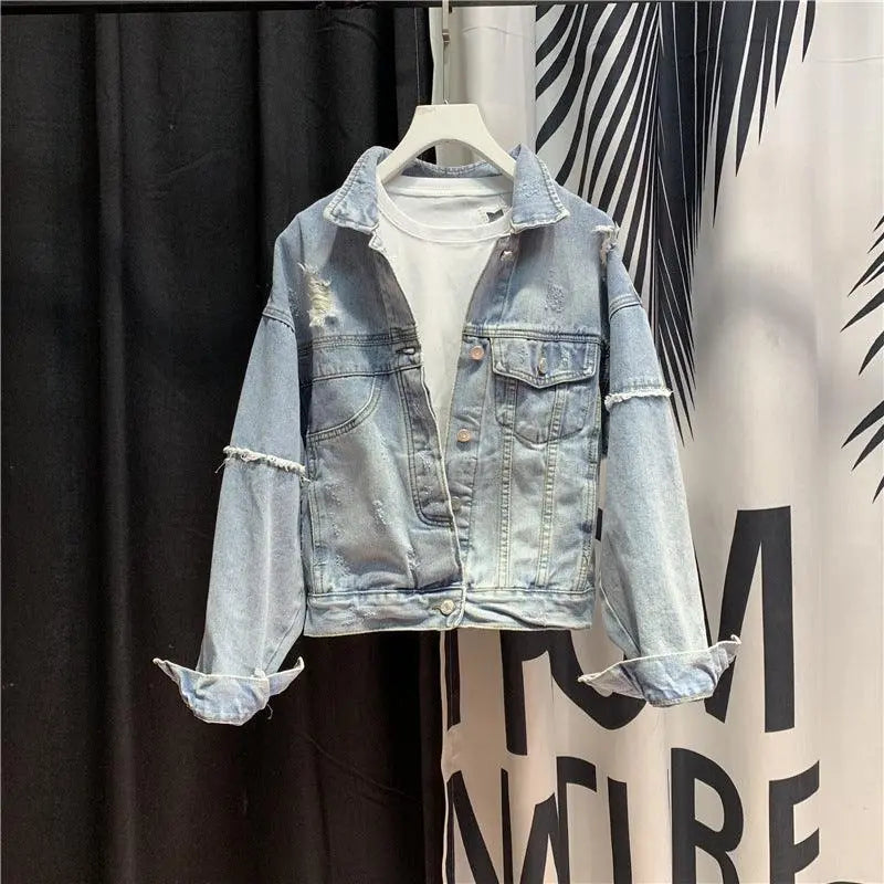 Light wash denim jacket with button front, chest flap pockets, and distressed sleeves