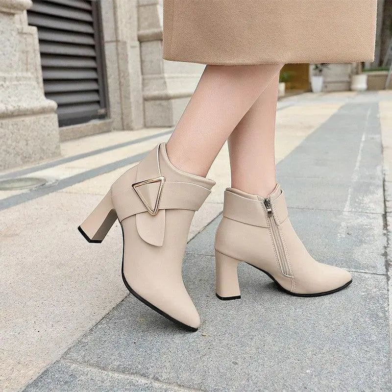 Beige ankle boots with mid-height block heel and metal triangle buckle detail