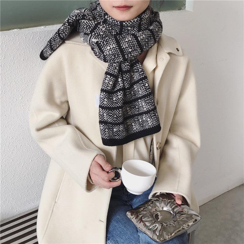Woolen knitted scarf in black and white checkered plaid pattern, draped