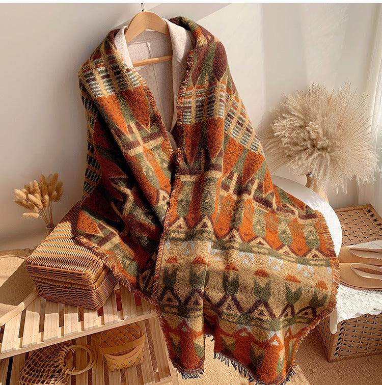 Thick plaid wool shawl in warm orange, green, and dark tones with fringe edge