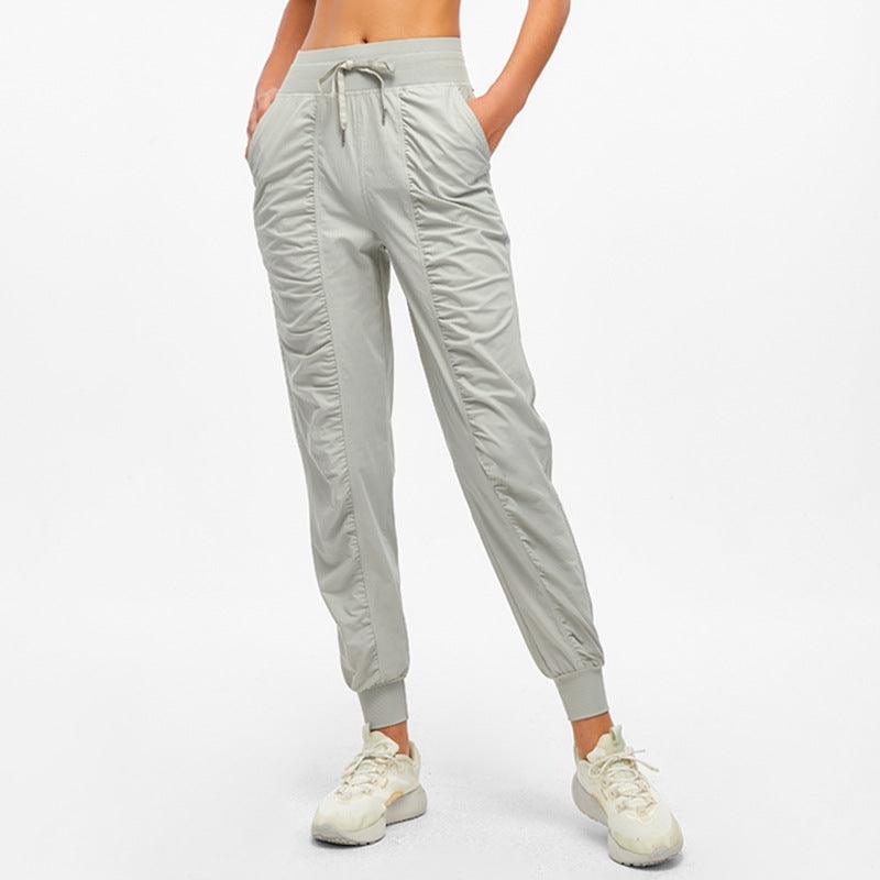 Light green jogger pants with drawstring waist and tapered ankle cuffs