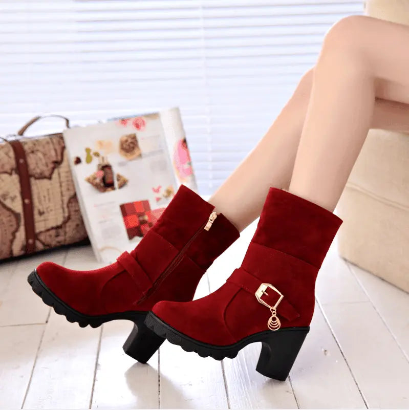 Red thick-heel snow boots with gold zipper detail and scalloped platform sole
