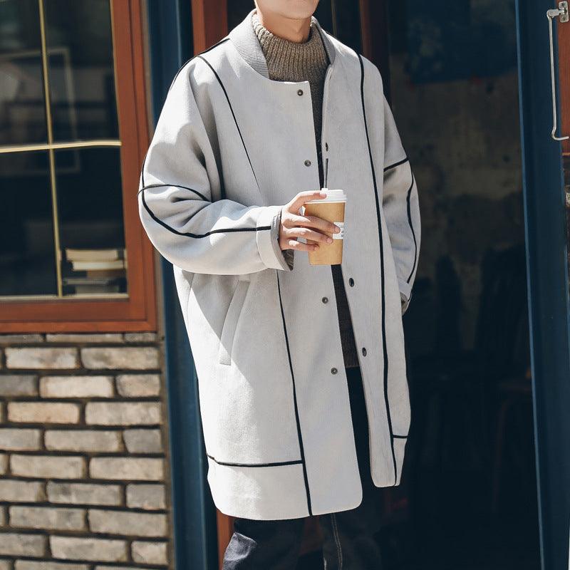 Oversized trench coat in light grey with black piping, button front, and side pockets