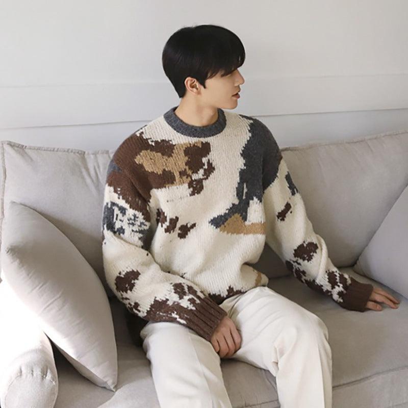 Loose round-neck sweater on model, viewed from back; cream knit with brown and dark animal pattern
