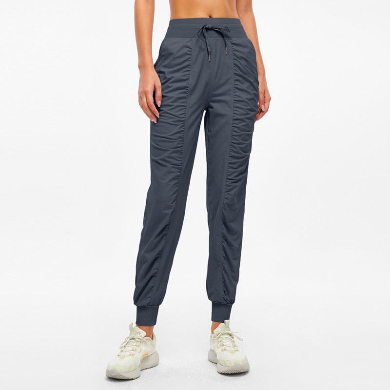 Navy jogger pants with drawstring waistband and tapered ankle cuffs