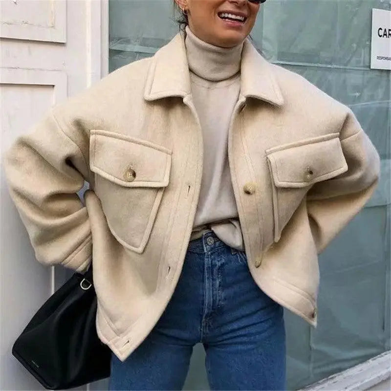 Light off-white knit jacket with flap pockets and button placket over a top