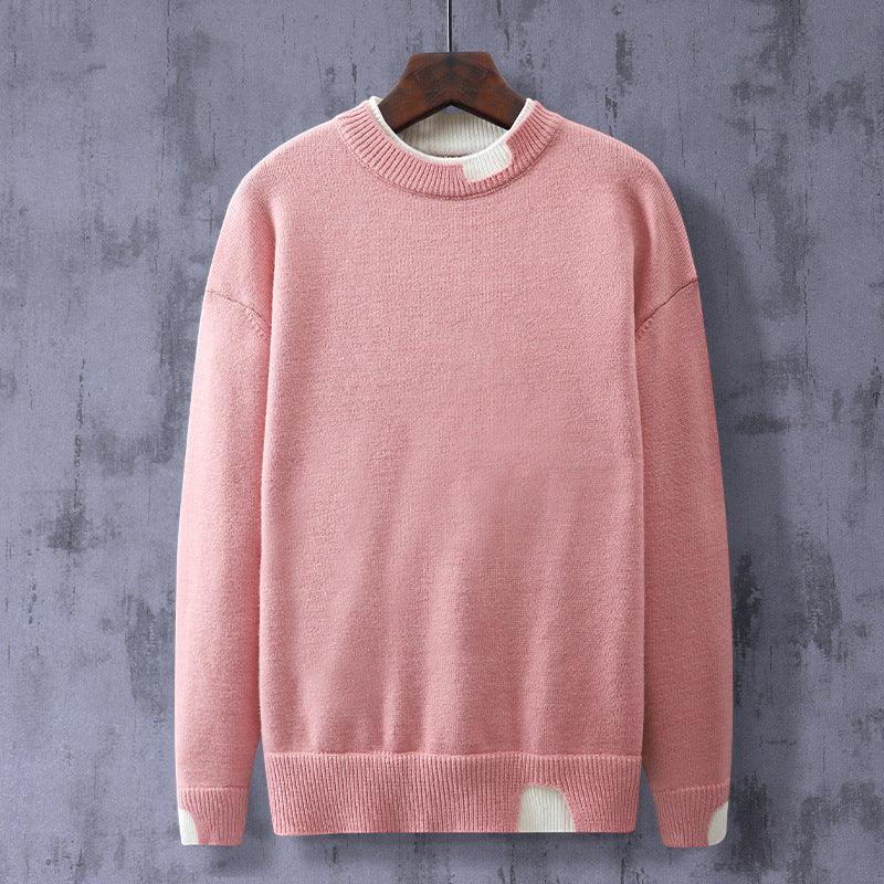 Pink knit crewneck sweater with long sleeves and ribbed hem