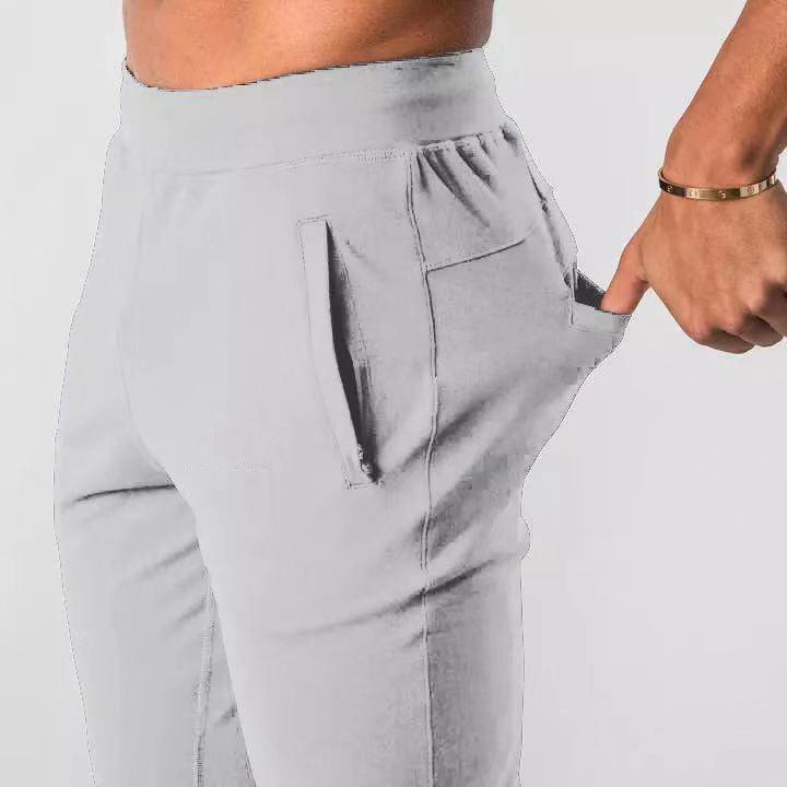 Men's sports trousers in light gray, elastic waistband with side zip pocket