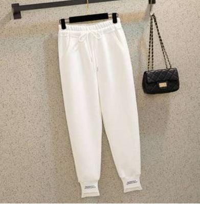 White harem jogger trousers with elastic waistband, drawstring, and cuffed hems