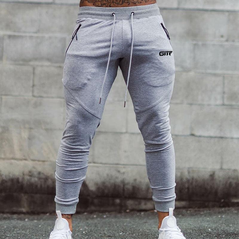 Light grey sport pencil pants with drawstring waist and tapered cuffed legs.