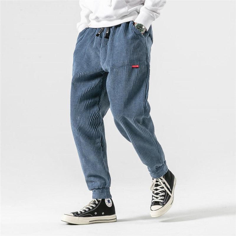 Men's blue corduroy jogger pants with drawstring waist and cuffed hems