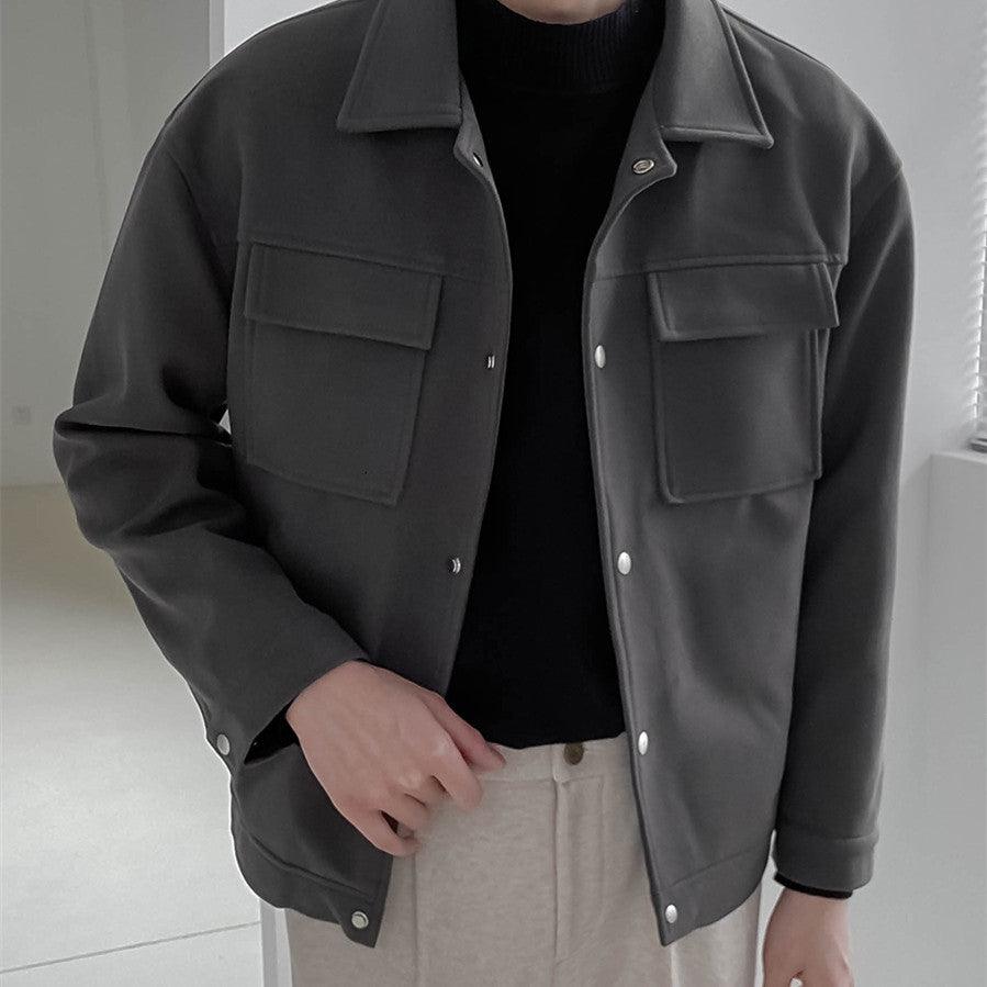 Men's black short work jacket with button front, pointed collar, and flap chest pockets