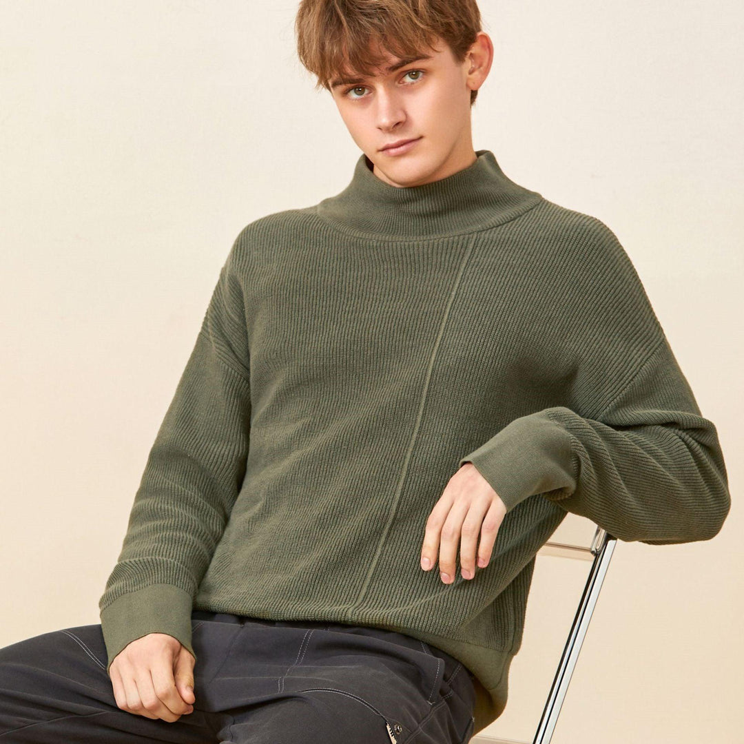 Loose green mock-neck knit sweater with long sleeves and ribbed collar, front view