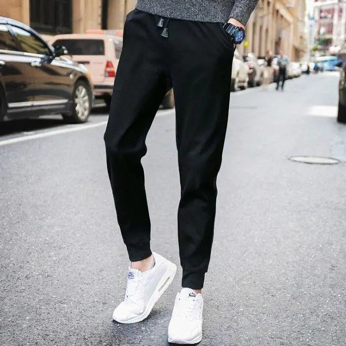 Black tapered casual jogger pants with elastic ankle cuffs