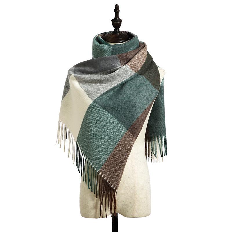 Fringed scarf with teal and brown-gray diamond check pattern draped on mannequin