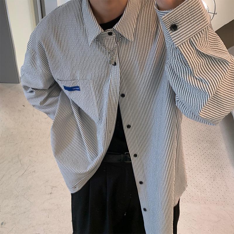 Light blue and white striped button-up shirt with chest pocket and dark buttons