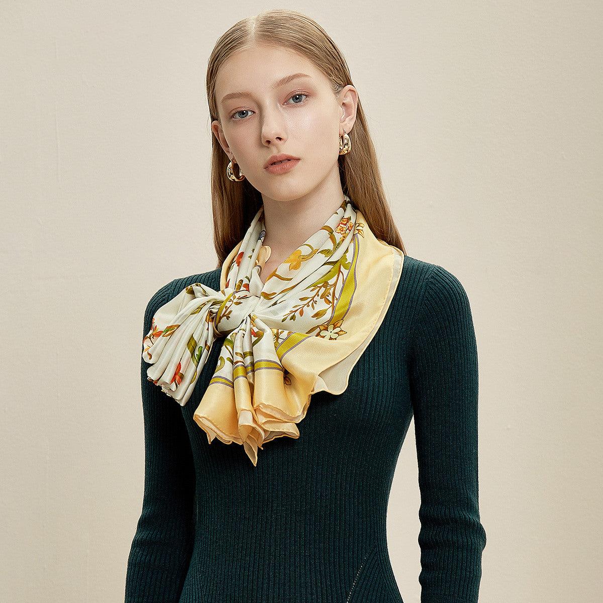 Silk scarf in cream and yellow with colorful butterfly and floral motif, draped long ends
