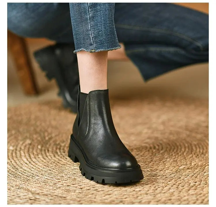 Black soft leather ankle boot with elastic side panels and chunky lug sole