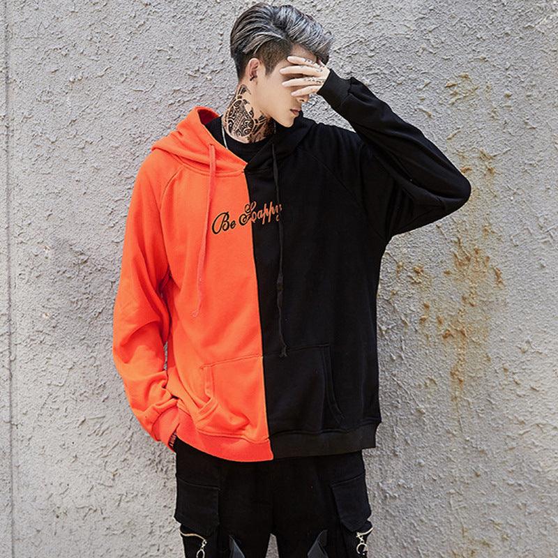 Color-blocking hoodie sweater with hood, orange and black panels with be happy text
