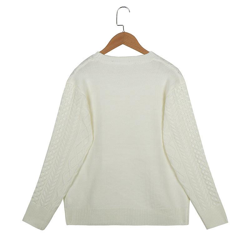White knit sweater back view on hanger, crew neck, long sleeves with cable details