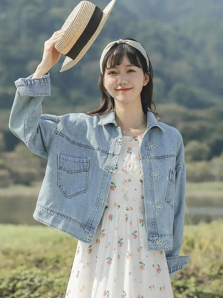 Light blue denim jacket with flap pockets and small flower embroidery on front