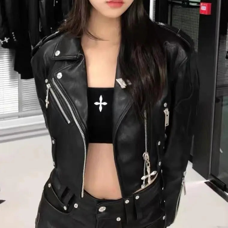 Black faux leather cropped jacket with studded cross accents and zip front