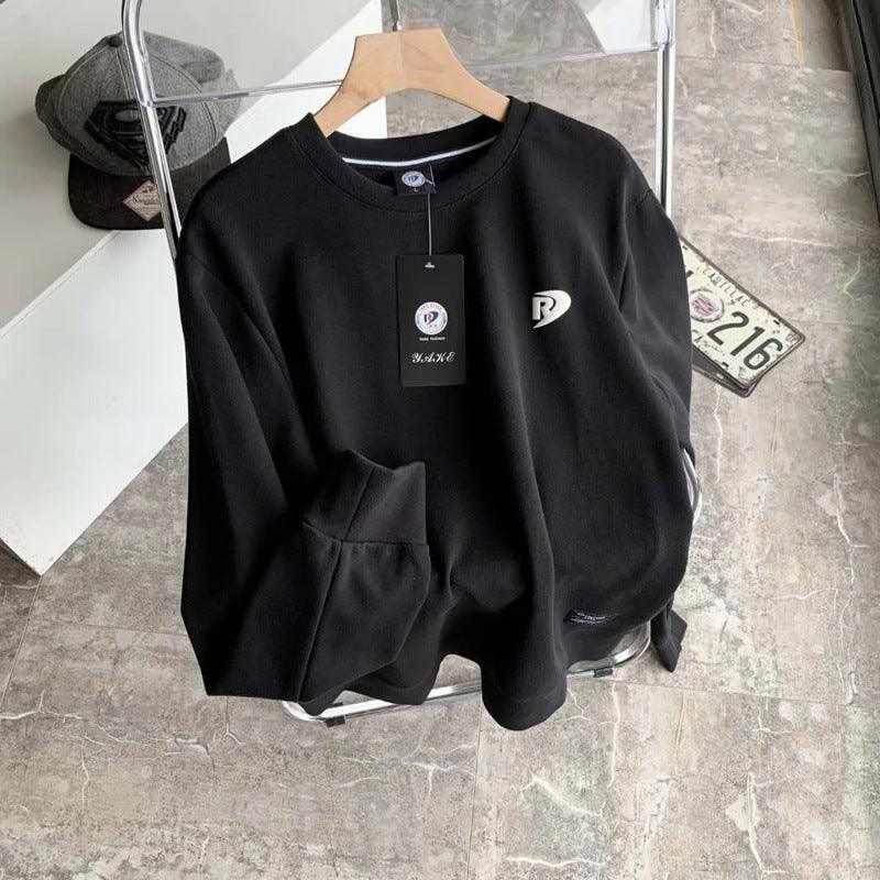 Black long-sleeve pullover base shirt with crew neck, kangaroo pocket, and chest logo tag.