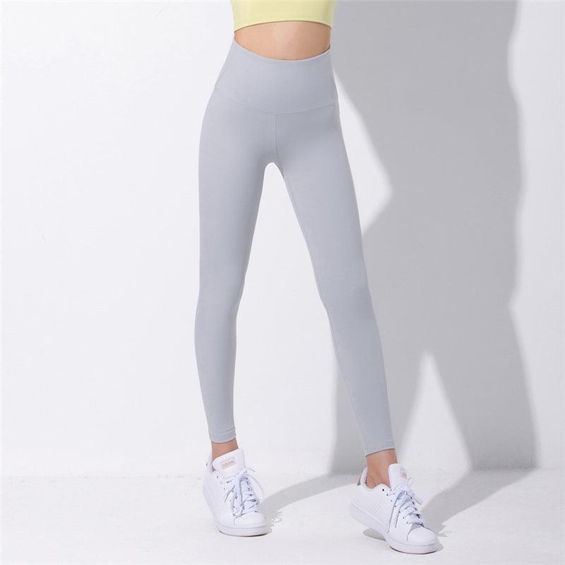 Light grey high-waist yoga pants with a fitted ankle-length leg.