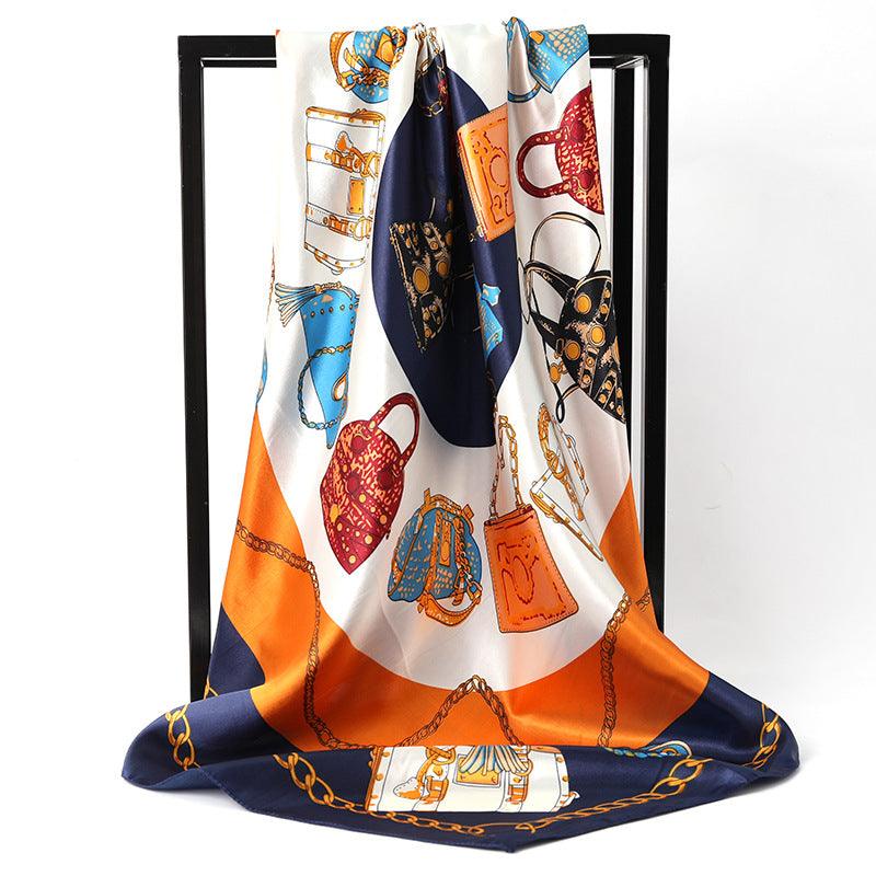 Women's silk scarf in white with orange and navy illustrated chain and bag print