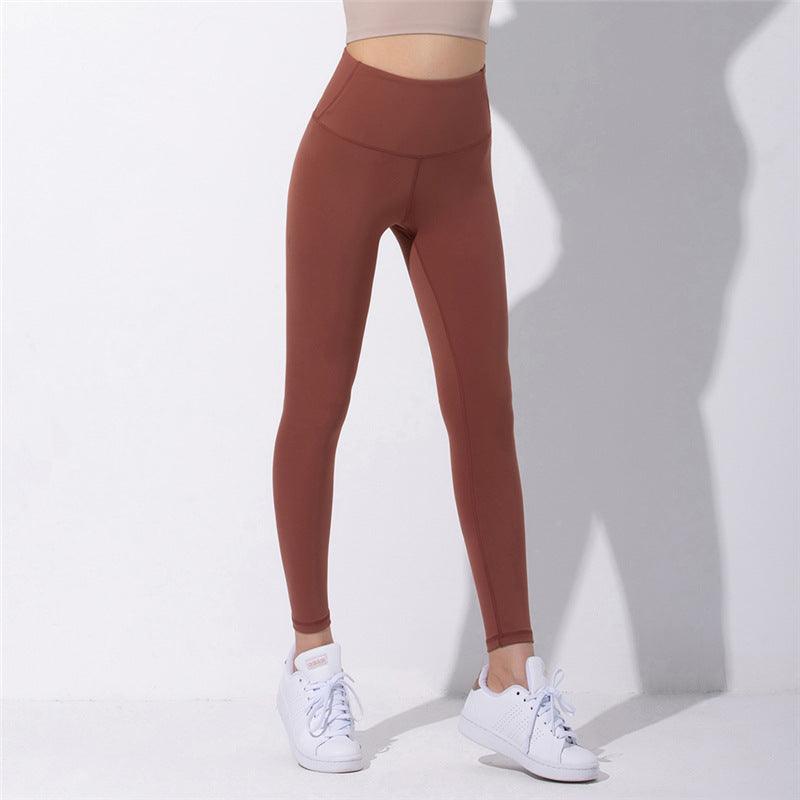 Rust brown high-waist yoga pants with a fitted ankle-length leg.