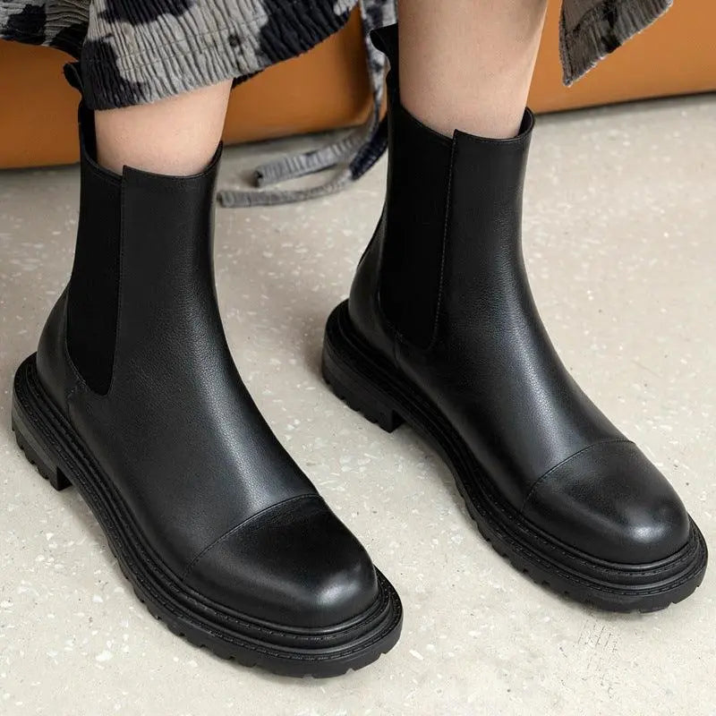 Black platform Chelsea boots with elastic side panels and thick lug sole