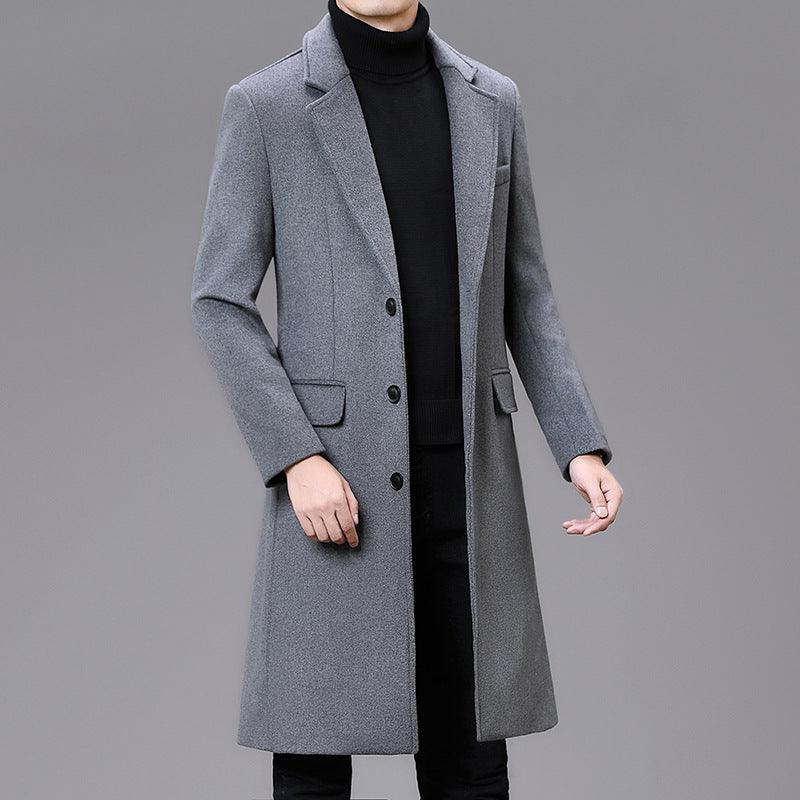 Men's grey long overcoat with notched lapels, button front, flap pockets, and side vents.