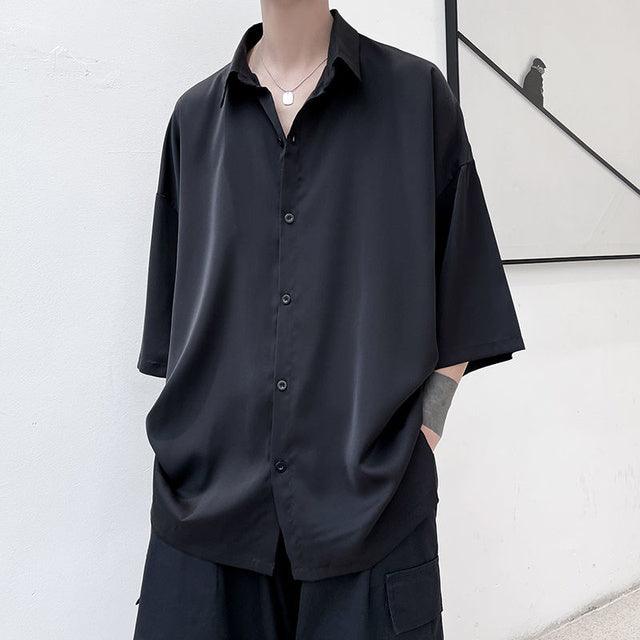 Black half-sleeve button-up shirt with spread collar and front placket