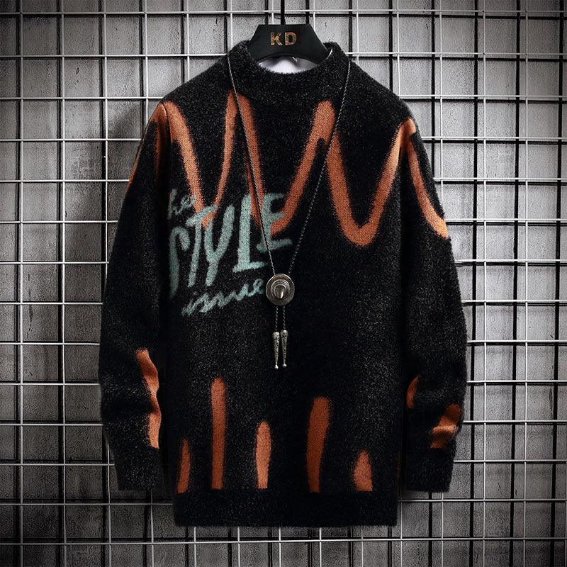Black half turtleneck knit sweater with orange abstract drip pattern and center button placket