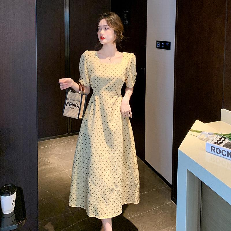 Yellow short-sleeve midi dress with square neckline, puff sleeves, and dark dot print