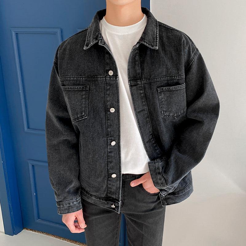 Black denim work jacket with button front, flap chest pockets, and side pockets