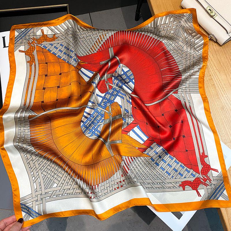 White and orange silk scarf with red accents, blue stripe details, and woven motif.